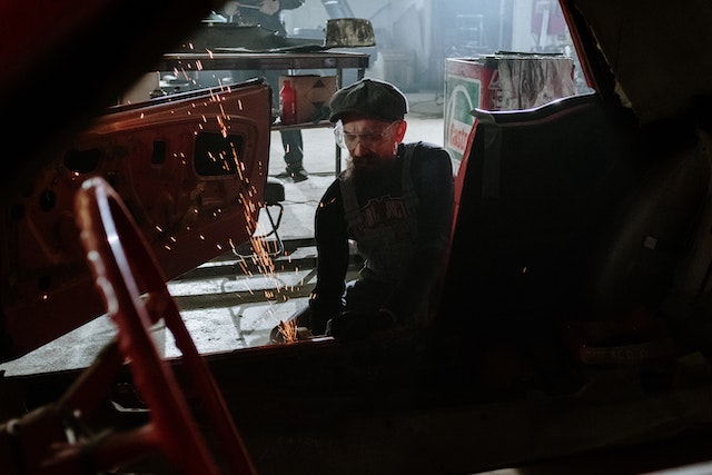 an auto mechanic works on metal