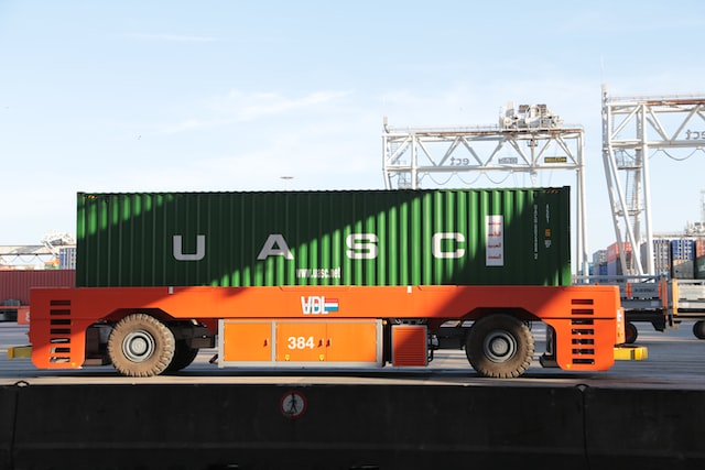 automated guided vehicle carrying a container at port of rotterdam